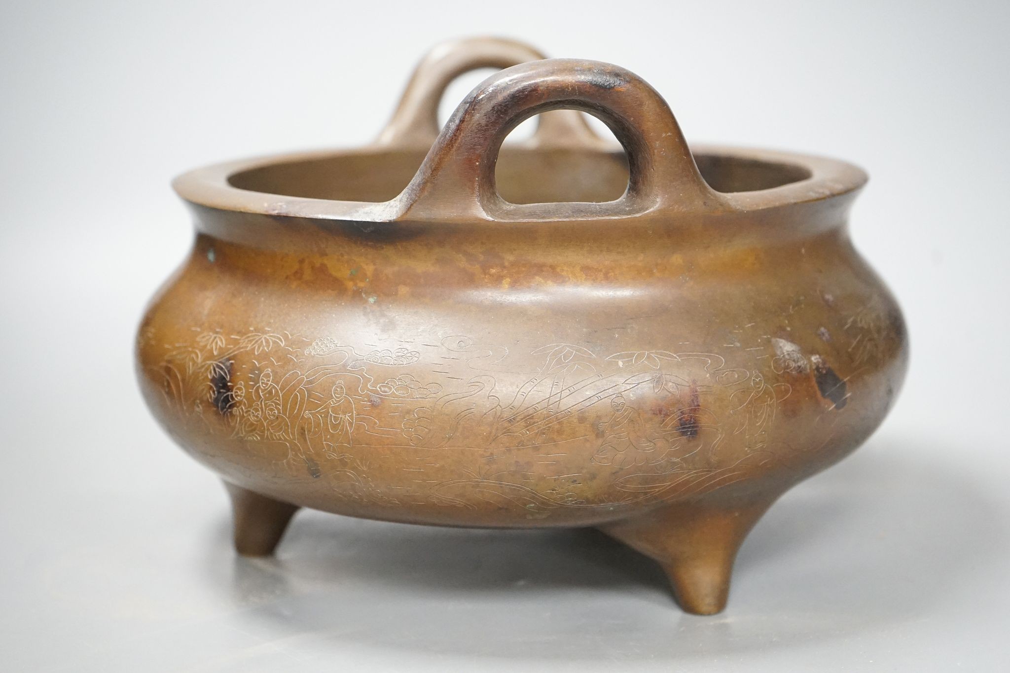 A large Chinese bronze tripod censer, Xuande mark, 24cm handle to handle